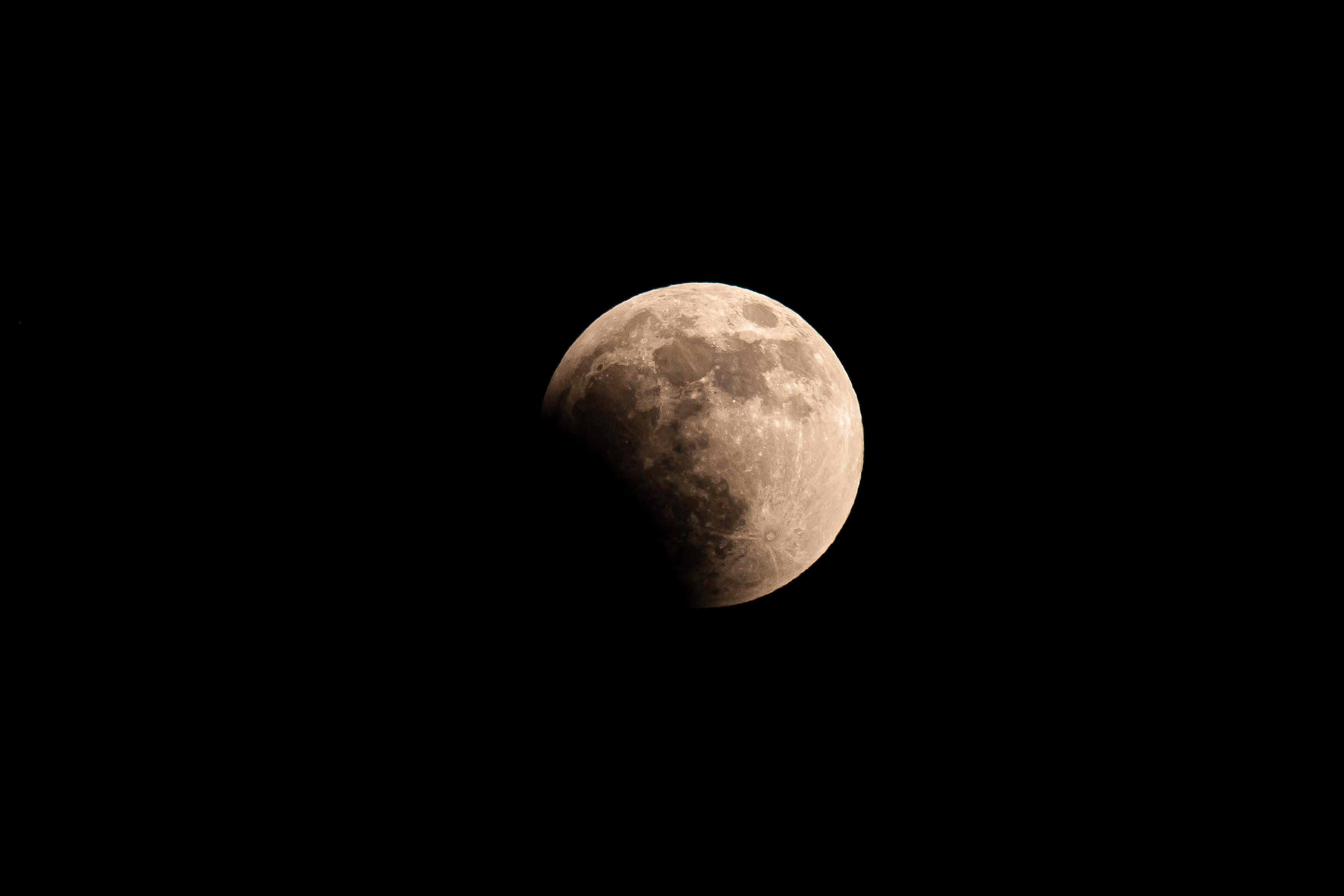 The full moon during a lunar eclipse, showing even more of the lower left portion covered in shadow