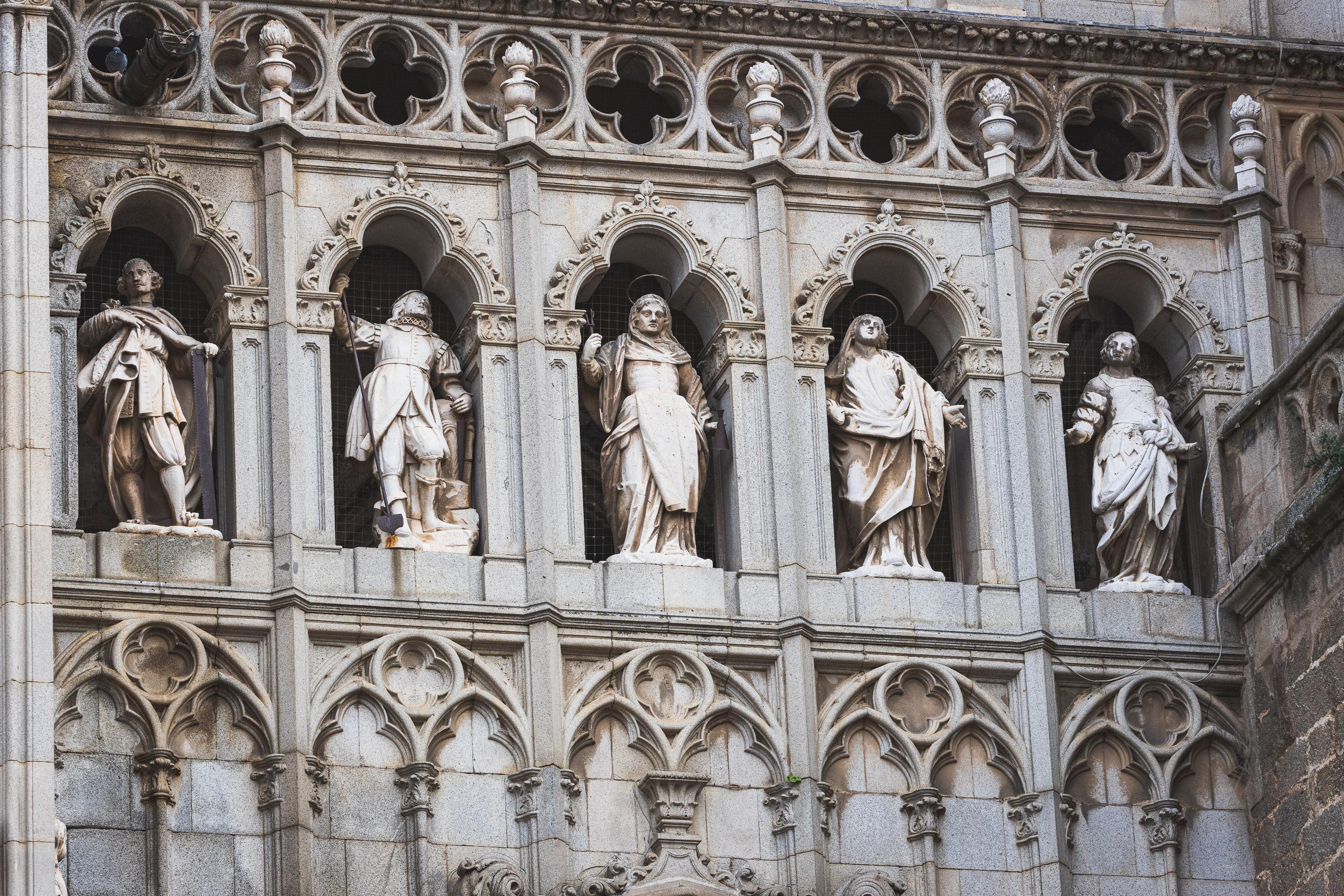 Architectural reliefs and statues outside Tolego Cathedral in Spain, carved into aging rock