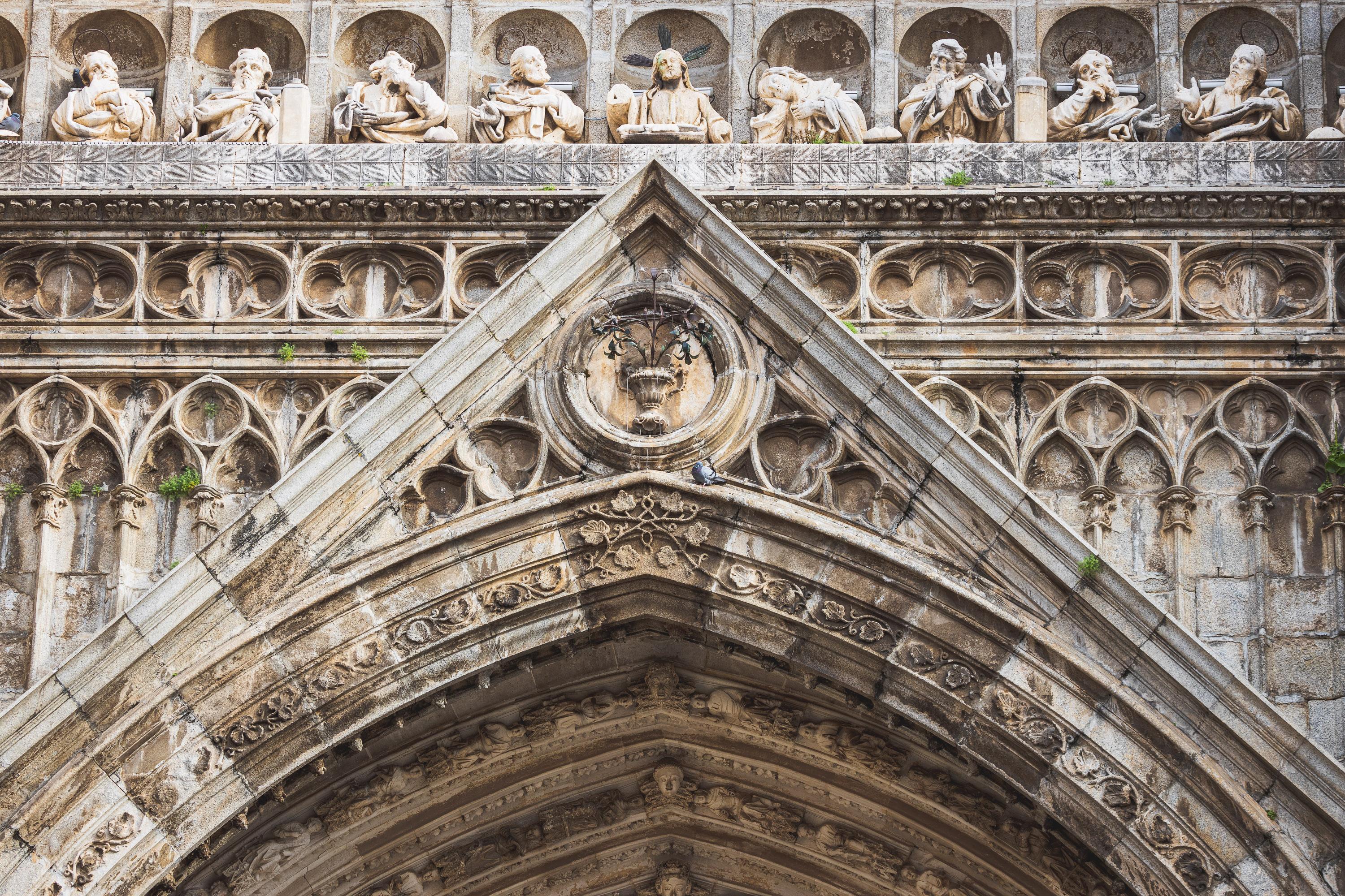 Architectural reliefs and statues outside Tolego Cathedral in Spain, carved into aging rock