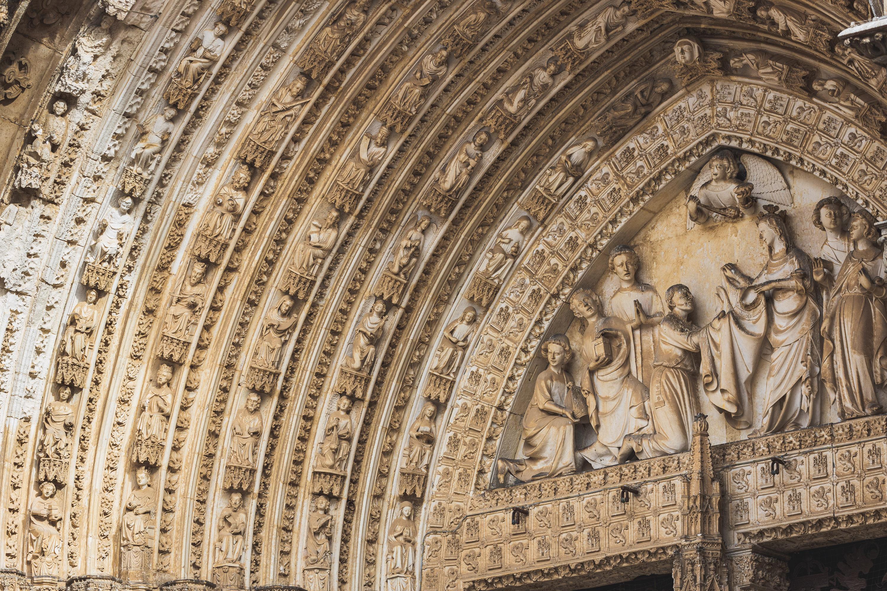 Architectural reliefs and statues outside Tolego Cathedral in Spain, carved into aging rock