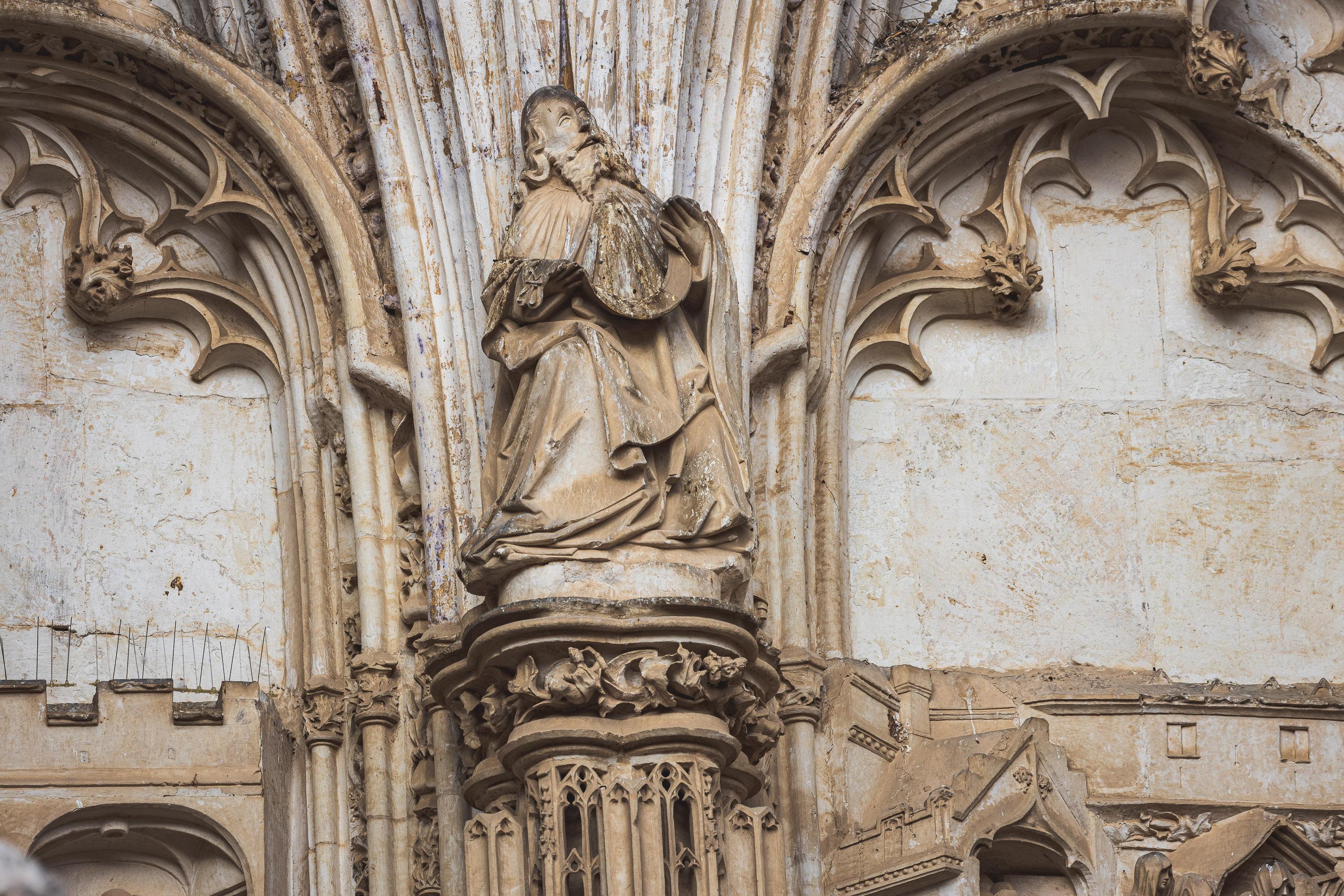 Architectural reliefs and statues outside Tolego Cathedral in Spain, carved into aging rock