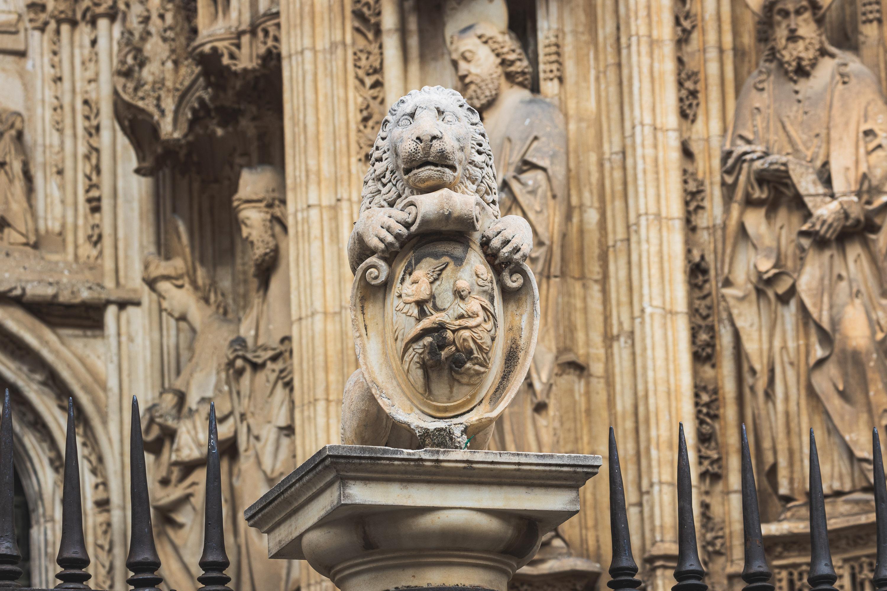 Architectural reliefs and statues outside Tolego Cathedral in Spain, carved into aging rock