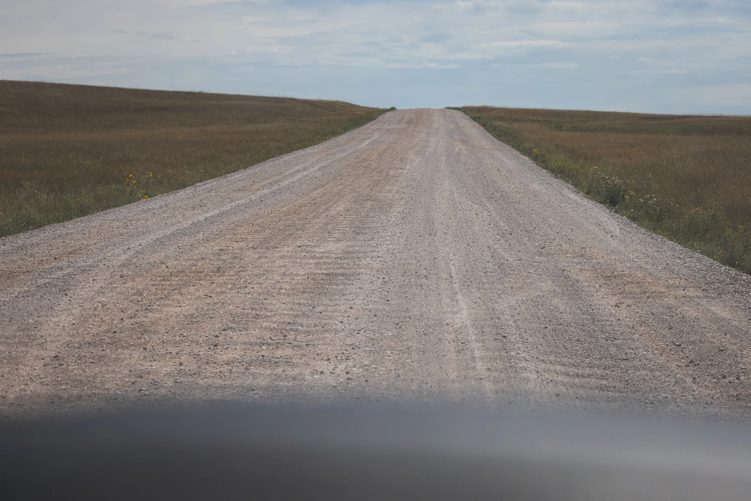 The dirt road through this portion of the park is pictured, showing deep rutting from vehicles passing