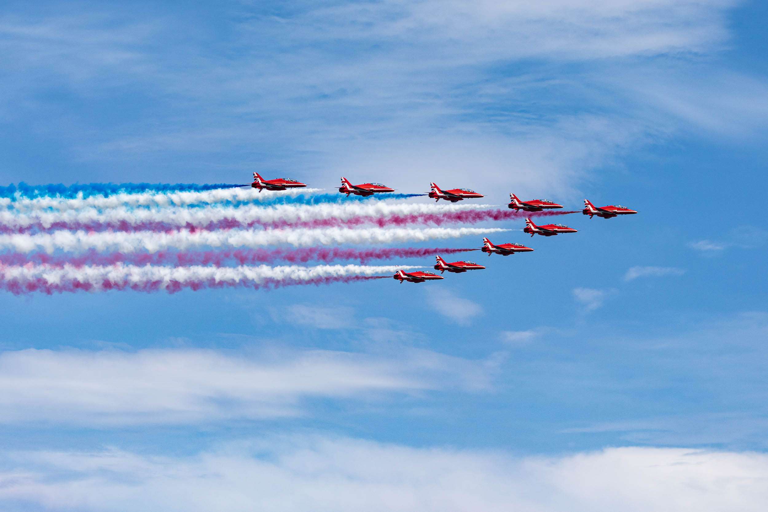The Royal Air Force Red Arrows performing with colorful smoke